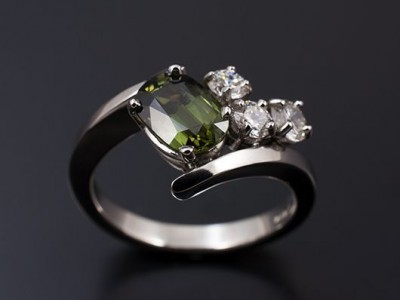 Platinum Hand Made Twist Ring with an Oval Green Sapphire 1.97ct and Round Brilliant Diamonds; 0.30ct (2) F SI, 0.21ct F SI.