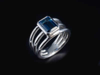 Ladies Blue Topaz Solitaire Engagement Ring, Platinum Rub over Set Halo Band Design, Emerald Cut Blue Topaz 1.98ct