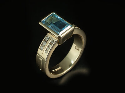 Ladies Topaz and Diamond Hinged Engagement and Wedding Ring, 9kt Yellow Gold Rub over and Channel Set Design, Emerald Cut Blue Topaz 4.11ct, Round Brilliant Cut Diamonds 0.09ct (8), Adjoined Wedding Band in 9kt Yellow Gold with Channel Set Sound Brilliant Cut Diamonds 0.24ct (6)