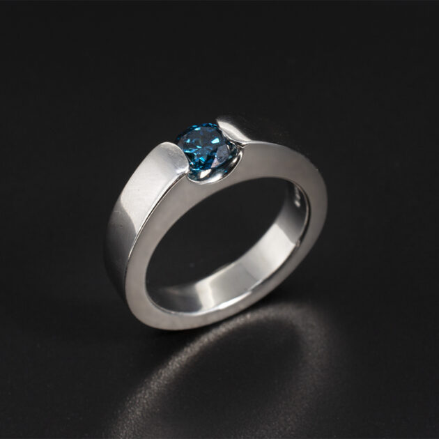 Blue Diamond Solitaire Ring Tension Set Design in Platinum, 0.50ct Blue Treated Round Brilliant Cut Diamond