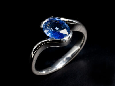 Ladies Solitaire Sapphire Dress Ring, Platinum Tension Set Twist Design, Oval Cut Blue Sapphire 1.41ct