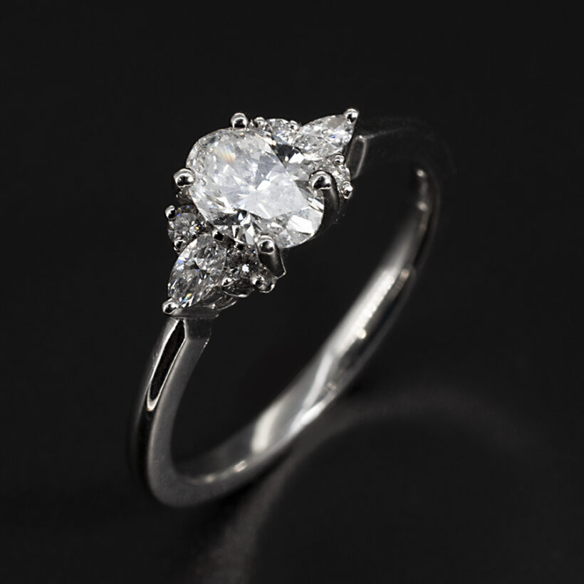 Platinum Claw Set Lab Grown Diamond Engagement Ring, Oval Cut 0.56ct, Marquise Cut 0.20ct Total (2), Round Brilliant Cut Diamonds 0.08ct Total (4)